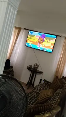 a living room with a flat screen tv on the wall at Recidencial sharael house in San Isidro