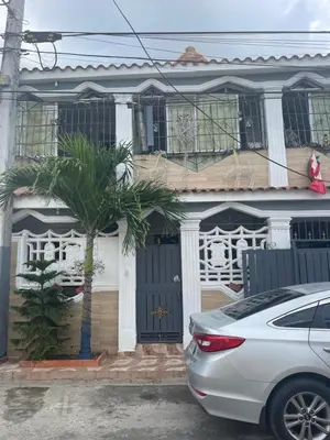 a house with a car parked in front of it at Recidencial sharael house in San Isidro
