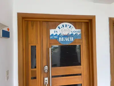 a sign on a door with a welcome to the beach sign at Beachfront Three Bedroom apt with Jacuzzi in Juan Pedro