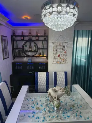 a dining room with a glass table and a chandelier at Beachfront Three Bedroom apt with Jacuzzi in Juan Pedro