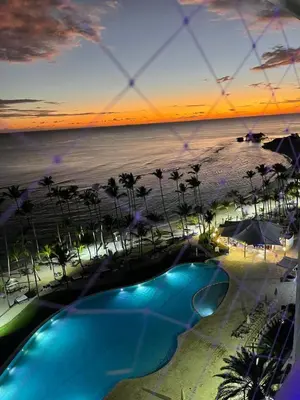 a view of the beach from a resort with a swimming pool at Beachfront Three Bedroom apt with Jacuzzi in Juan Pedro