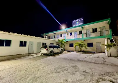a car parked in front of a hotel at night at Aparta El Mundo in Punta Cana