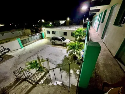 a car parked in a parking lot next to a building at Aparta El Mundo in Punta Cana