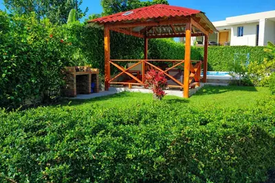 a gazebo in the middle of a yard at Modern Serviced Apartment with Free Wi-Fi, 24h Power & Private Parking in Sosúa