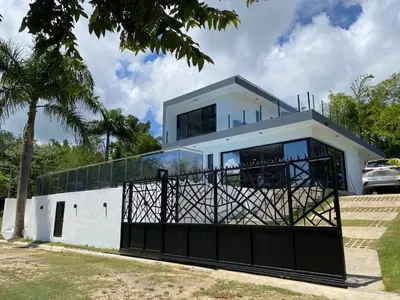 a house with a gate in front of it at Villa Tula in Sosúa