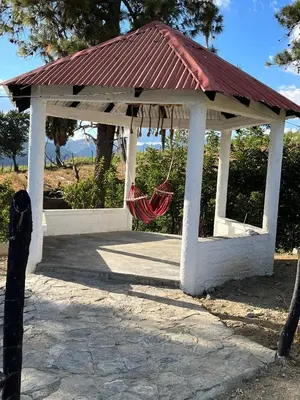a hammock in a gazebo with a red roof at Nice mountain cabin, with the best view
