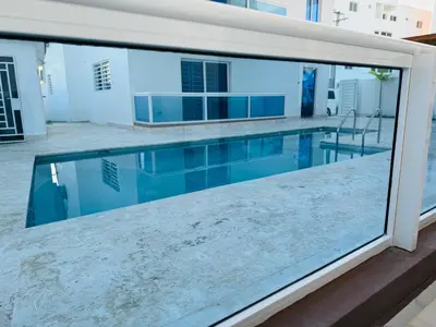 a view of a swimming pool from the balcony of a house at Residencial mar azul Bayahibe in Bayahibe