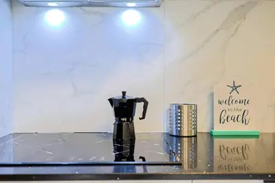 a coffee maker sitting on a glass counter top at Comfy Retreat Balcony Grill Pool in Punta Cana
