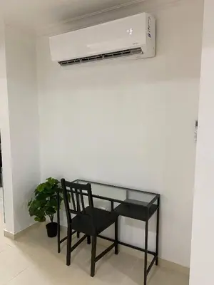 a black chair and a glass table and a air conditioner at Best location Big 3 Bdrs, Fully Stocked and A/C in Santo Domingo