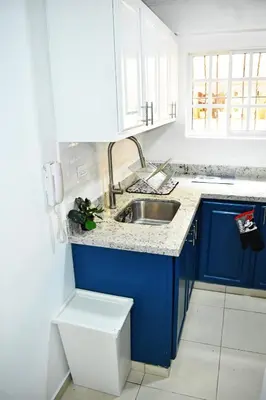 a blue and white kitchen with a sink and a toilet at Best location Big 3 Bdrs, Fully Stocked and A/C in Santo Domingo