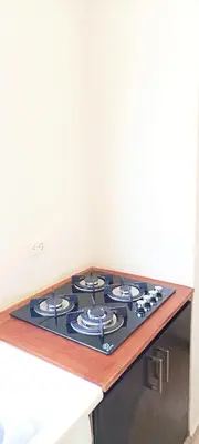 a stove top oven sitting on top of a kitchen counter at Apartamento en Residencial Los Pinos Cotui in Cotuí
