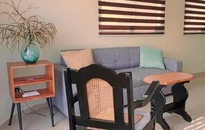 a living room with a couch and a table at Apartamento en Residencial Los Pinos Cotui in Cotuí