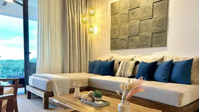 a living room with a couch and a table at ALL-NEW Modern and Stylish Apartment with Rooftop Infinity Pool in Las Terrenas