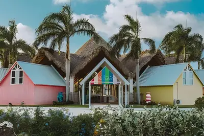a group of houses with palm trees in the background at Gardenia B31 in Punta Cana