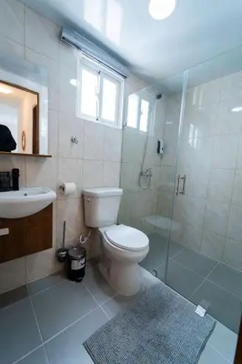 a bathroom with a toilet and a shower and a sink at SoliMar Caribeño in Boca Chica