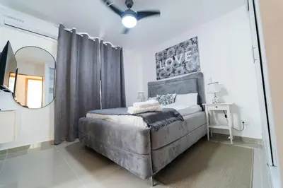 a bedroom with a large bed and a mirror at SoliMar Caribeño in Boca Chica