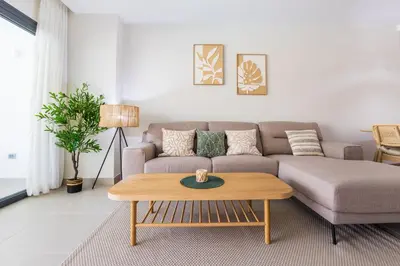 a living room with a couch and a coffee table at Brand New 2BR Stylish Apartment in the Heart of Punta Cana, Gardenia Gated Community in Punta Cana