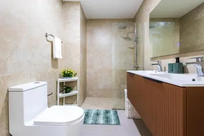 a bathroom with a toilet and a sink and a shower at Brand New 2BR Stylish Apartment in the Heart of Punta Cana, Gardenia Gated Community in Punta Cana
