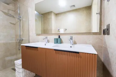 a bathroom with a sink and a mirror at Brand New 2BR Stylish Apartment in the Heart of Punta Cana, Gardenia Gated Community in Punta Cana