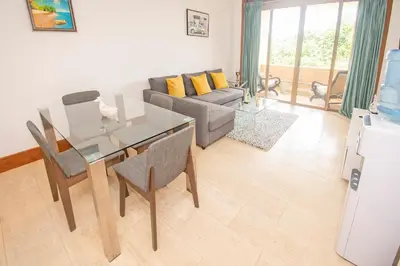 a living room with a table and a couch at Espectacular Apto en Casa de Campo Los Altos 3 in La Romana