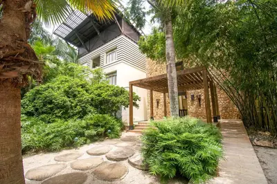 a house with a walkway in front of a building at Espectacular Apto en Casa de Campo Los Altos 3 in La Romana