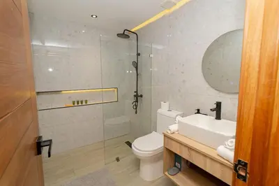 a bathroom with a toilet and a sink and a shower at Spacious 3BD Penthouse Private Rooftop Sea Breeze - Oasis in San Rafael del Yuma