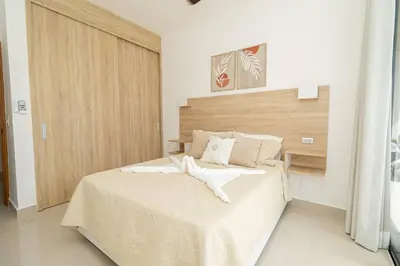a bedroom with a large bed with a wooden headboard at Spacious 3BD Penthouse Private Rooftop Sea Breeze - Oasis in San Rafael del Yuma