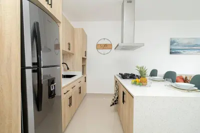 a kitchen with a stainless steel refrigerator at Spacious 3BD Penthouse Private Rooftop Sea Breeze - Oasis in San Rafael del Yuma