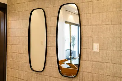 a mirror is hanging on a wall at Views, pool and gym, 2 BR family friendly in Santiago de los Caballeros
