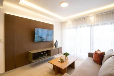 a living room with a couch and a tv at Views, pool and gym, 2 BR family friendly in Santiago de los Caballeros
