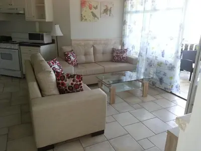 a living room with a couch and a table at Los Balcones in Sosúa