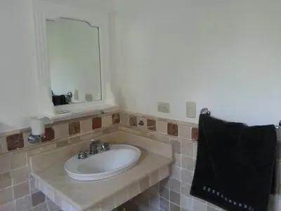 a bathroom with a sink and a mirror at Los Balcones in Sosúa