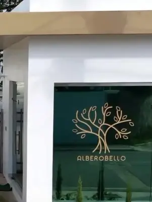 a sign on the side of a building with a tree on it at Luxury first floor Apartment Pool kingside suite in Santiago de los Caballeros