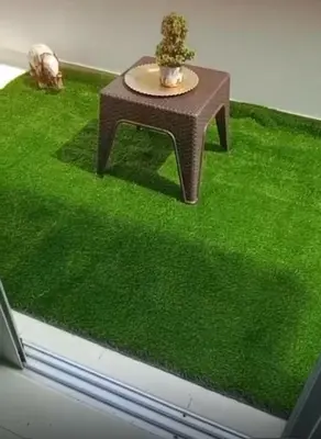 a table with a plant on top of green grass at Luxury first floor Apartment Pool kingside suite in Santiago de los Caballeros