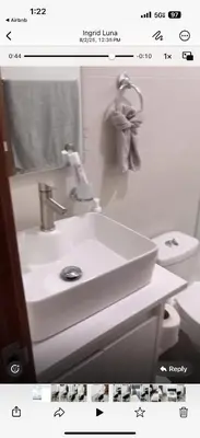 a bathroom with a white sink and a toilet at Luxury first floor Apartment Pool kingside suite in Santiago de los Caballeros