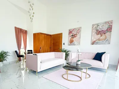 a living room with two couches and a table at Elysium Suits Maximum Comfort in Punta Cana