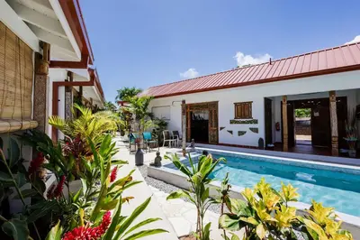 a house with a swimming pool next to a building at Bali Style Boutique Hotel in Las Terrenas
