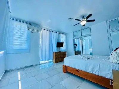 a bedroom with a bed and a ceiling fan at Apartartamento cabarete in Cabarete