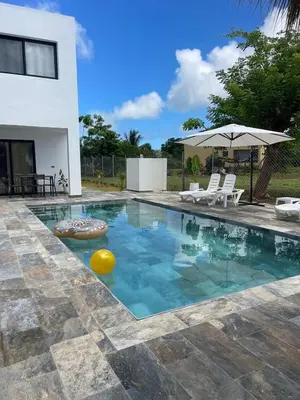 a swimming pool in front of a house at Apartamento Entre Playas 2- 3 pax, 4 min de la playa in Las Galeras