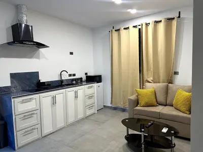 a living room with a couch and a kitchen at Apartamento Entre Playas 2- 3 pax, 4 min de la playa in Las Galeras