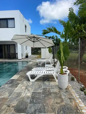 a pool with two lounge chairs and an umbrella at Apartamento Entre Playas 2- 3 pax, 4 min de la playa in Las Galeras