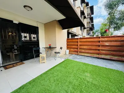 a patio with a green lawn in front of a building at Luxurious and comfortable 1 level in Juan López