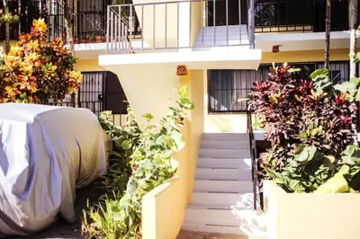 a building with a bunch of plants next to a staircase at nNomad Apartment steps to Sirena - Apartment in Sosúa