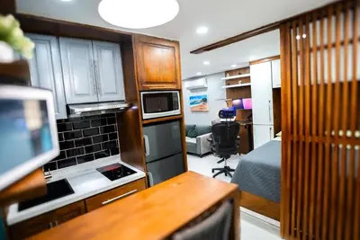 a small room with a kitchen and a bedroom at nNomad Studio mins from Sirena - Apartment in Sosúa