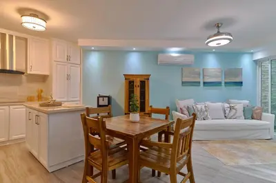 a kitchen and living room with a table and a couch at Costa Del Sol Juan Dolio 2BR Sunset, Beach Front in Juan Dolio