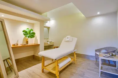 a white chair in a room with a mirror at Caribbean Paradise Aquarella 22th in La Puntica de Juan Dolio