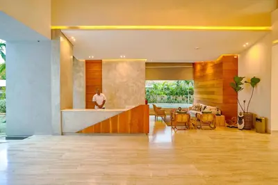 a man standing in a lobby with a dining room at Caribbean Paradise Aquarella 22th in La Puntica de Juan Dolio