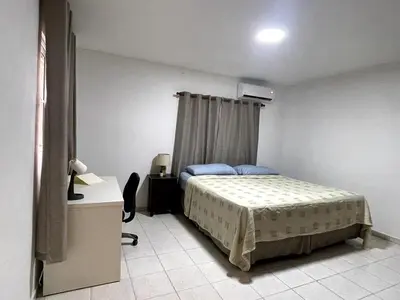 a bedroom with a bed and a dresser in it at Acogedor apartamento en Bella Vista, Casa Caribe in Santo Domingo
