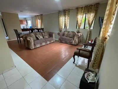 a living room with two couches and a table at Acogedor apartamento en Bella Vista, Casa Caribe in Santo Domingo