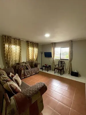 a living room with two couches and a couch at Acogedor apartamento en Bella Vista, Casa Caribe in Santo Domingo